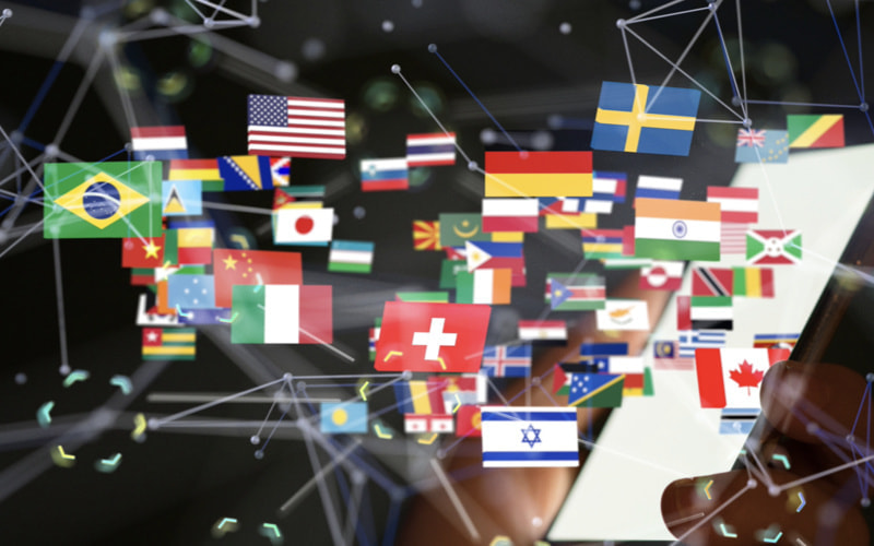 世界各国の国旗が空間に散らばっているイメージ図